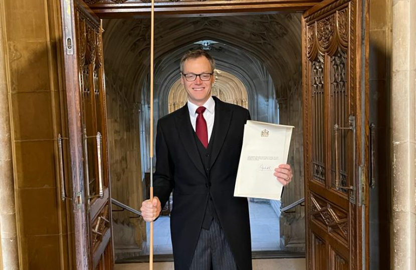 Michael holding a message from the Queen to the House of Commons, wearing Morning suit and holding a staff of office 