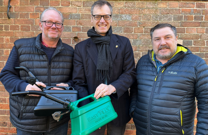 Michael with the inventors and the jerry can