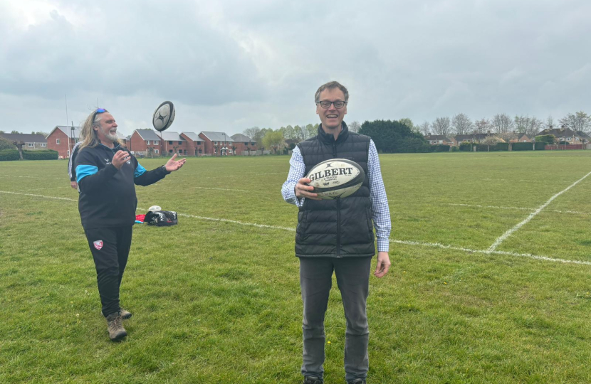 Michael holding rugby ball