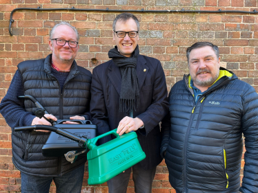 Michael with the inventors and the jerry can